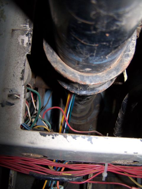 1973 Ford Bronco - Messy wiring harness with multiple colored wires and a large black conduit visible.
