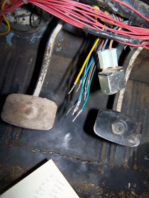 1973 Ford Bronco - A close-up view of the wiring harness and pedals inside a vehicle's cabin.