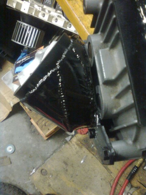 1984 Ford Bronco - This image shows a custom-fabricated adapter plate for a supercharger installation, welded seams.