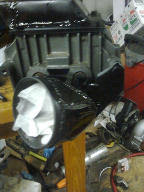 1984 Ford Bronco - Close-up of an engine part, possibly a supercharger intake, with paper wadding inside.