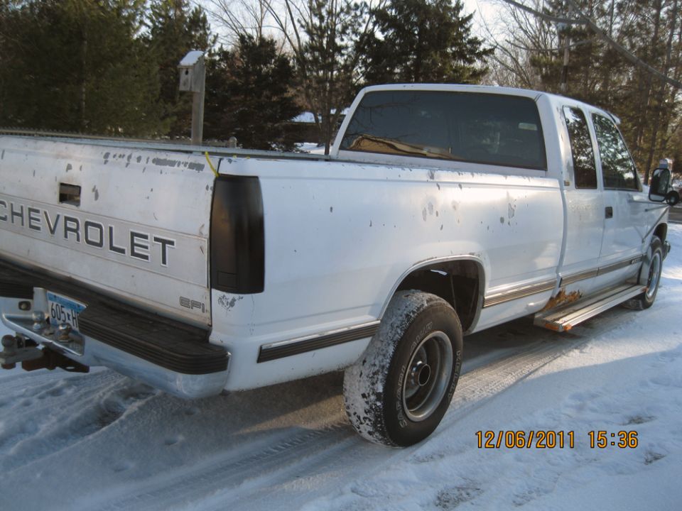 White Chevrolet pickup truck, rear 3/4 view. Dated 12/06/2011