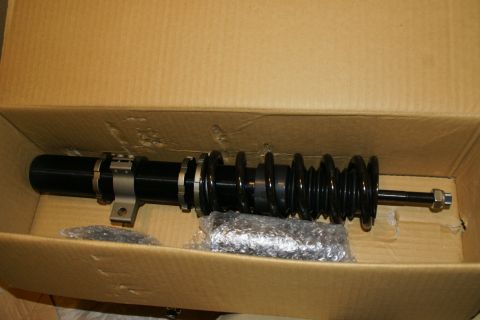 1995 Ford Taurus - A single coilover suspension assembly is shown inside its shipping box.