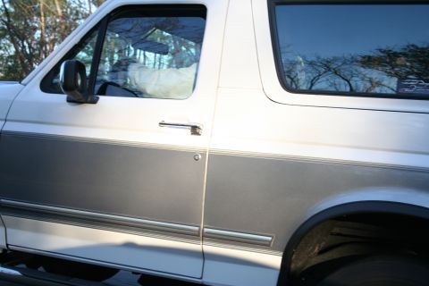 1982 Ford Bronco - This Ford Bronco features a two-tone paint scheme with a gray stripe along the lower body.