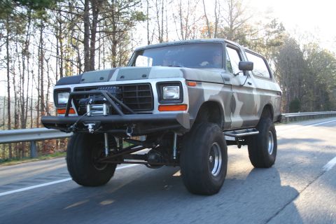1982 Ford Bronco - Modified 1978 Ford Bronco with large tires and camouflage paint seen on the road.