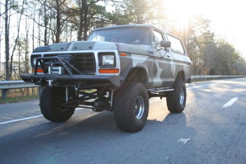 1982 Ford Bronco - This lifted Ford Bronco features a custom front bumper and winch, with a camouflage paint job.