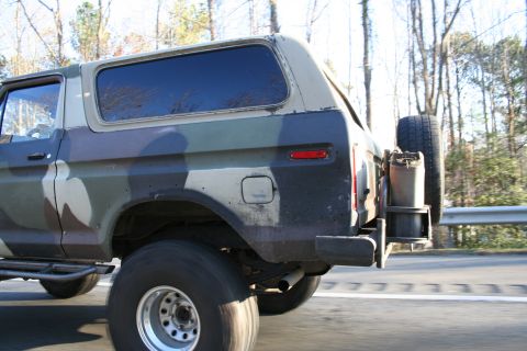 1982 Ford Bronco - This Ford Bronco, painted in camouflage, is equipped with a rear-mounted spare tire and jerry can.