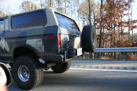 1982 Ford Bronco - This 1982 Ford Bronco features a camouflage paint scheme and a rear-mounted spare tire carrier.