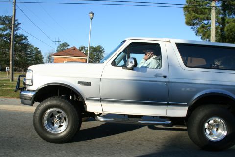 1982 Ford Bronco - This 1992 Ford Bronco features a two-tone paint scheme and running boards, seen from the side.