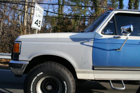 1982 Ford Bronco - This pickup truck, possibly from the early 1980s, is seen next to a speed limit sign.