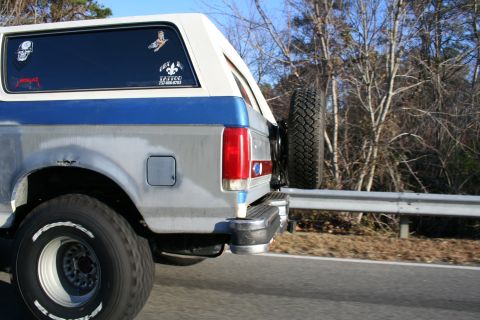 1982 Ford Bronco - This 1982 Ford Bronco shows its rear quarter panel and spare tire, with various stickers on the window.