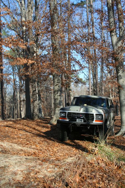 1982 Ford Bronco - This lifted Ford Bronco navigates a leaf-strewn path through a wooded area.