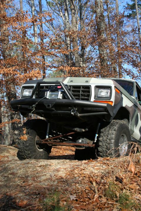 1982 Ford Bronco - This modified Ford Bronco is shown off-road with a custom front bumper and camouflage paint scheme.