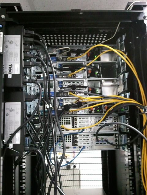 1985 Ford F-150 - A server rack filled with Dell servers and a tangle of network cables is shown from a top-down perspective.