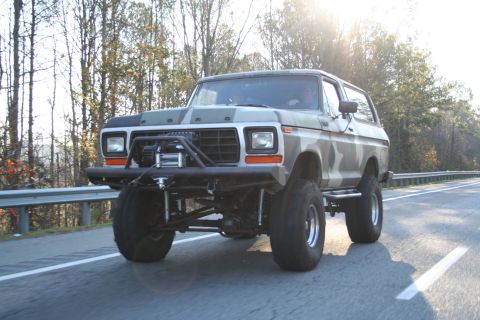 1982 Ford Bronco - This heavily modified Ford Bronco features a camouflage paint scheme and off-road upgrades.