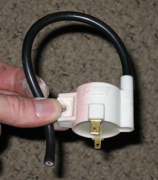 White ignition coil with black wire and brass connectors. Text reads 'POWER'