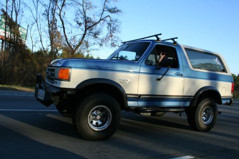 1982 Ford Bronco - This two-tone Ford Bronco is captured in a side profile, its build and roof rack.