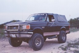 1988 Ford Bronco - This lifted 1988 Ford Bronco features a removable soft top and aggressive off-road tires, ready for adventure.