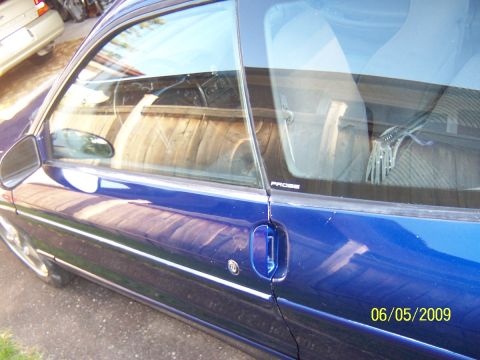 1993 Ford Probe - A blue coupe's side profile is shown, with a partial view of the interior and a 'PROBE' decal on the window.