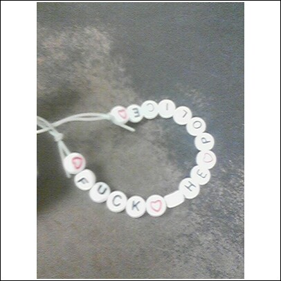 1996 Ford Bronco - A close-up photo shows a beaded bracelet with the words 'FUCK HOPE' spelled out.