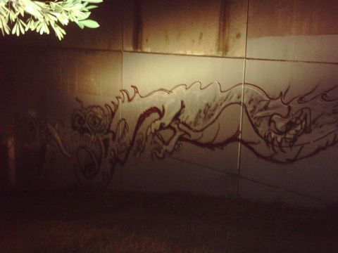 1996 Ford Bronco - A mural of a dragon is painted on a tiled wall, illuminated by a light source from above.