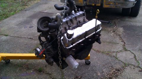 1989 Ford Bronco - Engine removed from a vehicle and placed on an engine stand for maintenance or repair.