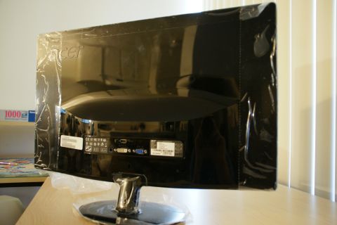 1993 Ford Taurus - The rear view of a black Acer monitor, still in its protective plastic wrapping, shows various input and output ports.