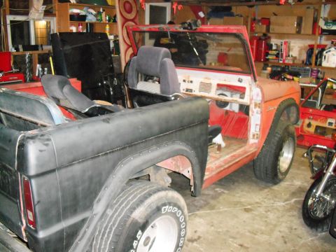1968 Ford Bronco - A partially disassembled 1968 Ford Bronco sits in a garage, awaiting restoration.