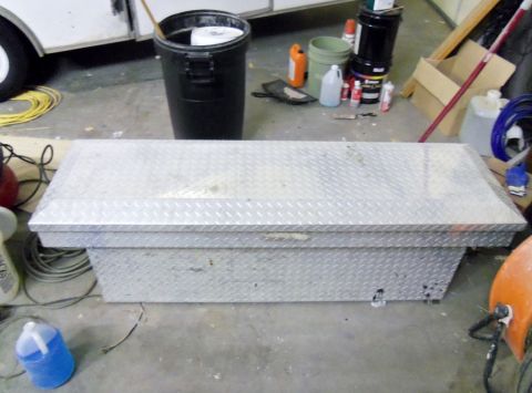 2000 Mercury Grand Marquis - An aluminum toolbox sits on a concrete floor surrounded by cleaning supplies and other items in a workshop setting.
