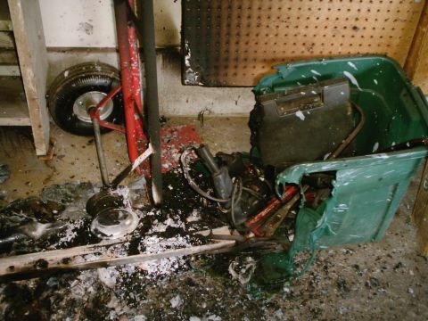 1989 Ford Bronco - Debris and damaged items litter the floor following a garage fire.