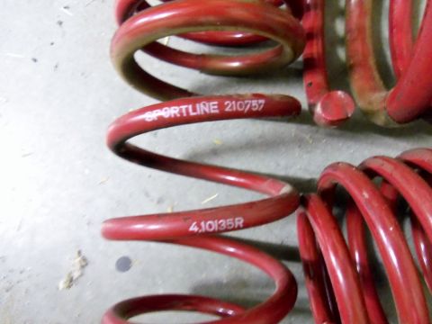 2000 Mercury Grand Marquis - Close-up of red coil springs showing part numbers and brand name.