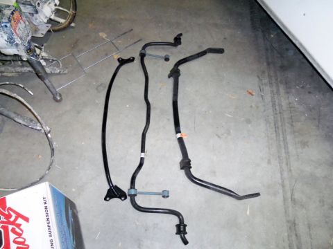 2000 Mercury Grand Marquis - Various suspension components laid out on a garage floor next to a box for a suspension kit.