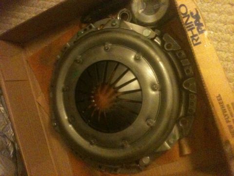 1993 Ford Bronco - A clutch kit, branded RHINO PAC, is shown inside its packaging. The box also indicates it is a flywheel.
