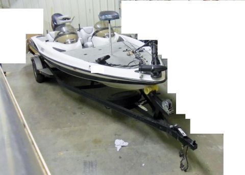 2000 Mercury Grand Marquis - Bass boat on a trailer parked indoors.
