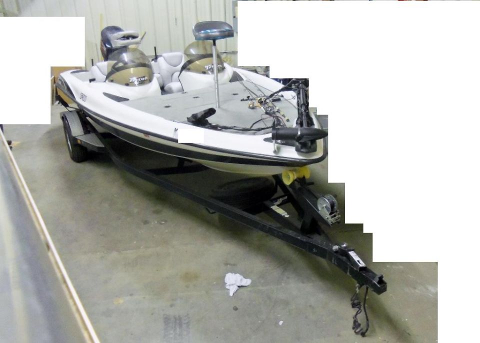 bass boat on a trailer in a garage