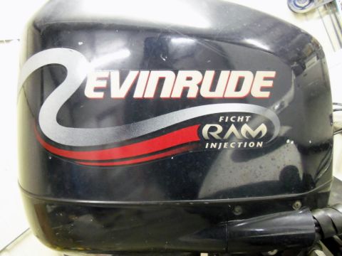 2000 Mercury Grand Marquis - Close-up of a black Evinrude outboard motor, 'Ficht Ram Injection' graphics.
