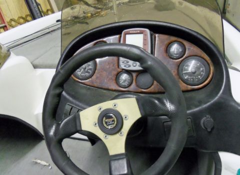 2000 Mercury Grand Marquis - Interior view of a boat's helm, showing the steering wheel and instrument panel.