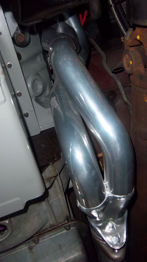 1991 Ford Bronco - Close-up view of a shiny chrome exhaust manifold with two distinct pipes.