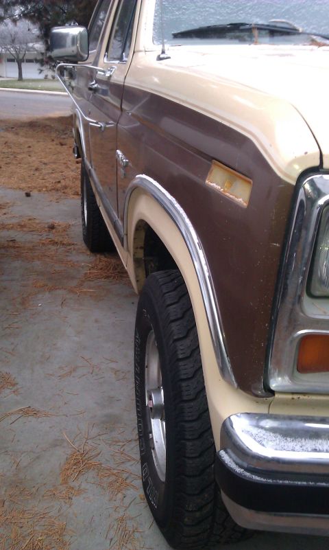 1984 Ford Bronco - Front fender and wheel of a two-tone brown and tan Ford Bronco from the early 1980s.