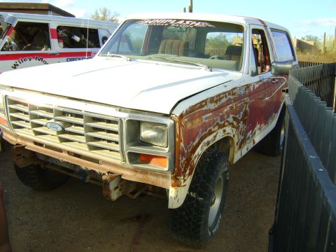1968 Ford Mustang - This white Ford Bronco shows significant rust damage on its body panels.