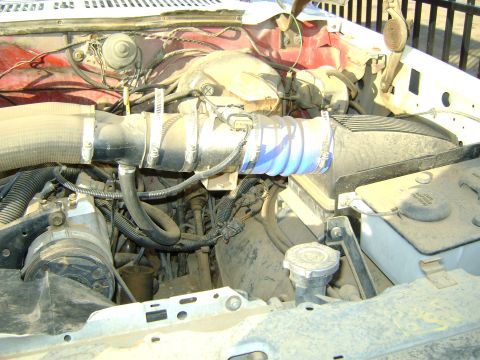 1968 Ford Mustang - The engine bay of a vehicle, showing various components and wiring, covered in a layer of dust.