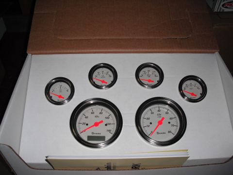 1968 Ford Bronco - A set of Shark brand gauges, including a speedometer and tachometer, are displayed in a cardboard box.