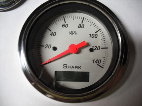 1968 Ford Bronco - A close-up of a Shark brand speedometer gauge, showing MPH markings and a digital display.