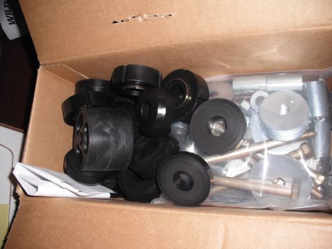 1968 Ford Bronco - Overhead shot of a cardboard box holding a complete body mount kit: a pile of black polyurethane or rubber bushings in several diameters al…
