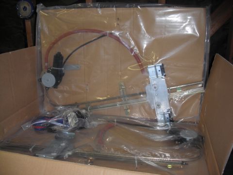 1968 Ford Bronco - A window regulator mechanism is shown packaged in plastic inside a cardboard box.