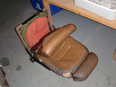1969 Volvo P1800 - Car seat with worn leather and visible internal structure, likely removed from a vehicle.