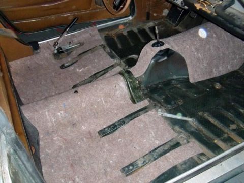 1969 Volvo P1800 - Interior of a car undergoing restoration, with new sound deadening material on the floor.