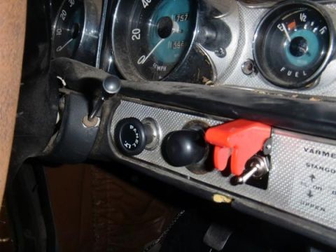 1969 Volvo P1800 - Dashboard interior showing gauges and switches, including a fuel gauge and speedometer.