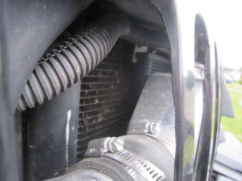2008 Jeep Wrangler - This image shows a close-up view of a vehicle's radiator and associated hoses and clamps.