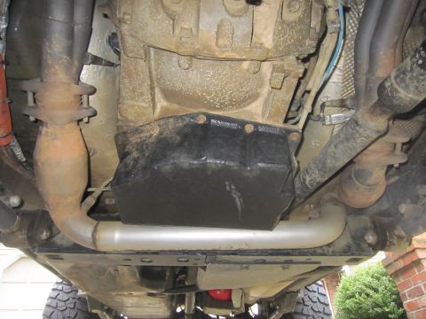 2008 Jeep Wrangler - The underside of a vehicle is visible, with focus on the engine and exhaust system components.