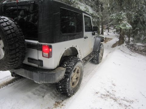 2008 Jeep Wrangler - Jeep Wrangler driving on a snow-covered forest road.